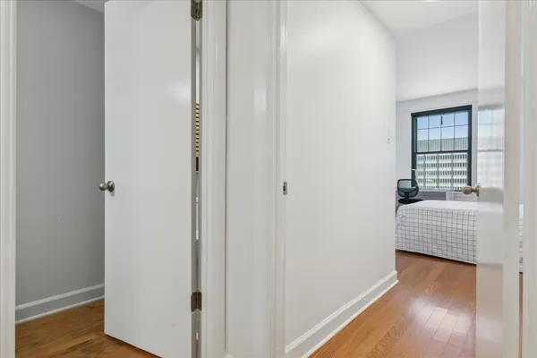 a hallway with sliding door and wooden floor
