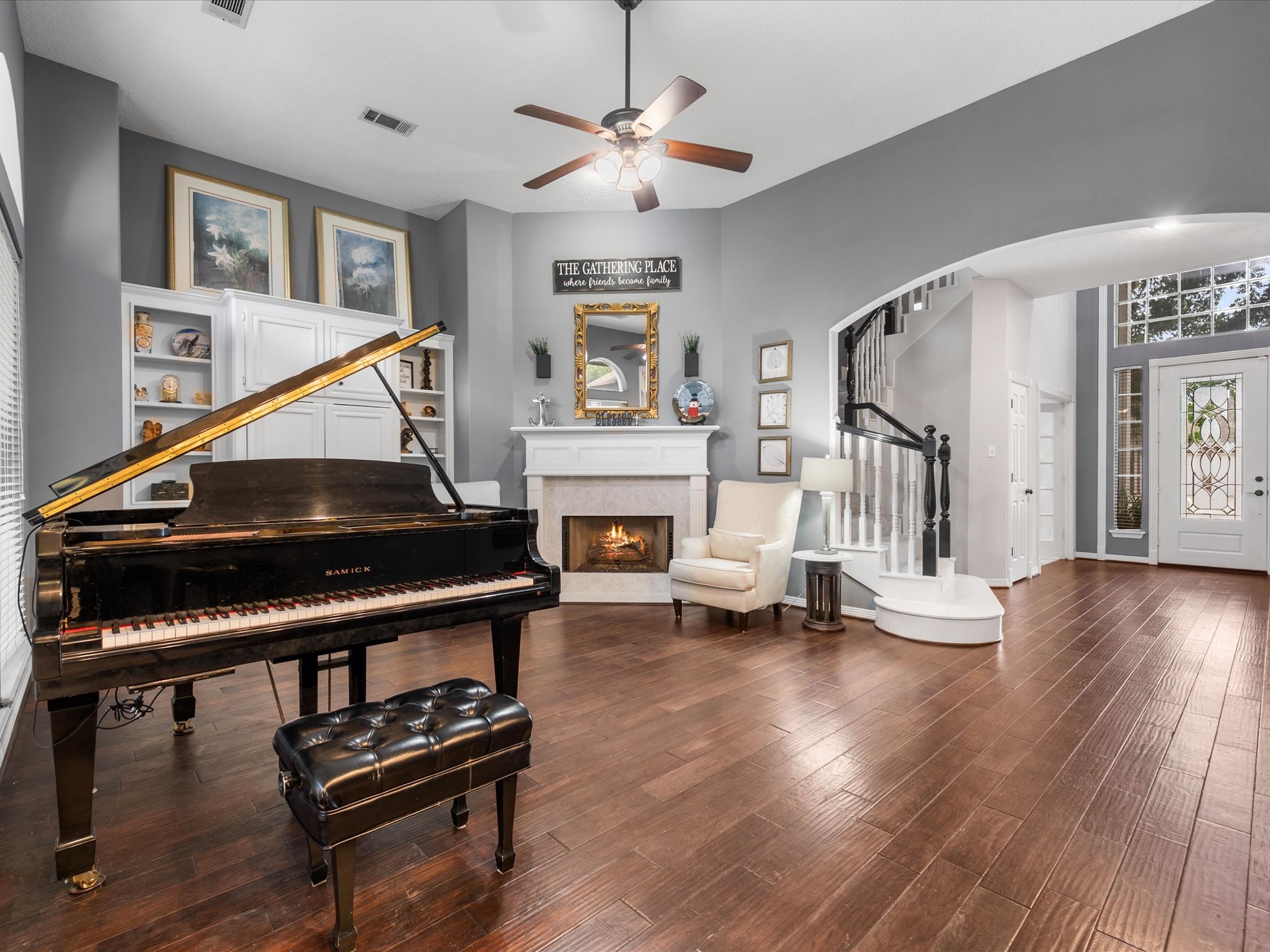5910 Center Ct Drive Spring, TX 77379 - Photo 11 of 50 Soaring ceilings, fresh paint, and wood flooring set a refined tone in this versatile living space, where a fireplace anchors the room and large proportions allow for both relaxed living and elegant entertaining.
