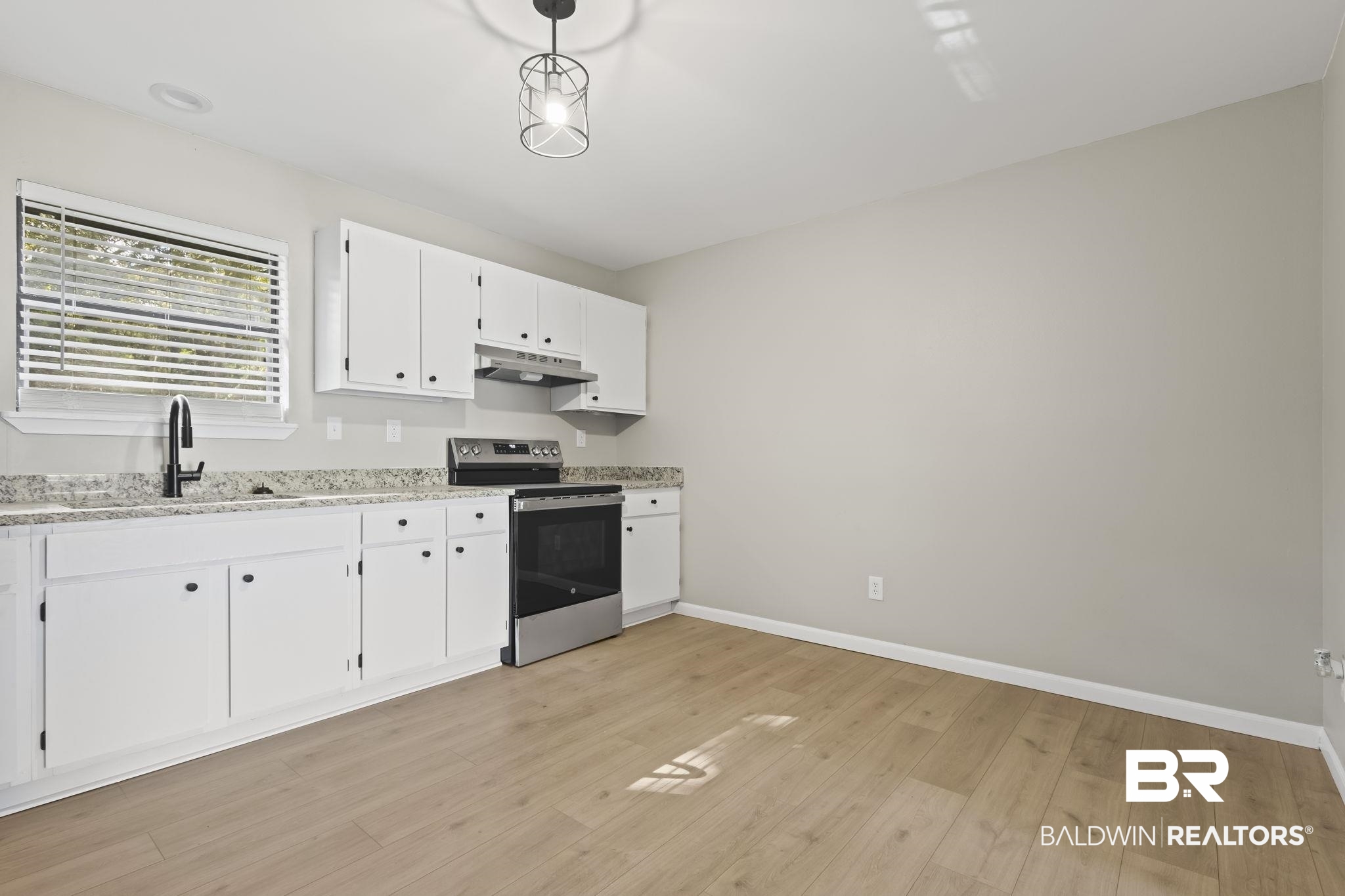 309 West Roosevelt Avenue Foley, AL 36535 - Photo 10 of 60 Kitchen with light wood-type flooring, sink, pendant lighting, electric range, and white cabinets