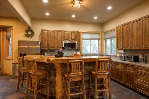 a large kitchen with a table and chairs