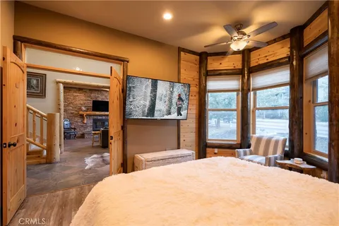 a bedroom with a large bed and a large window