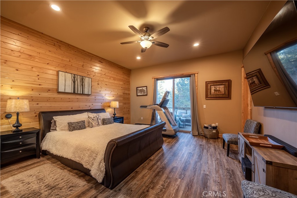 325 Stony Creek Road Big Bear Lake, CA 92315 - Photo 22 of 42 a bedroom with a bed and wooden floor