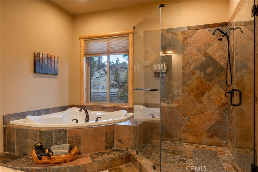 325 Stony Creek Road Big Bear Lake, CA 92315 - Photo 23 of 42 a bathroom with a tub and shower