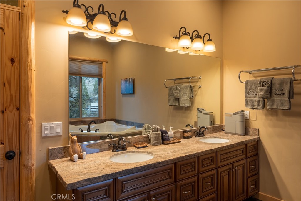 325 Stony Creek Road Big Bear Lake, CA 92315 - Photo 24 of 42 a bathroom with a sink vanity and a mirror