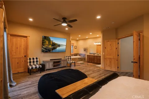 a bedroom with furniture and a flat screen tv