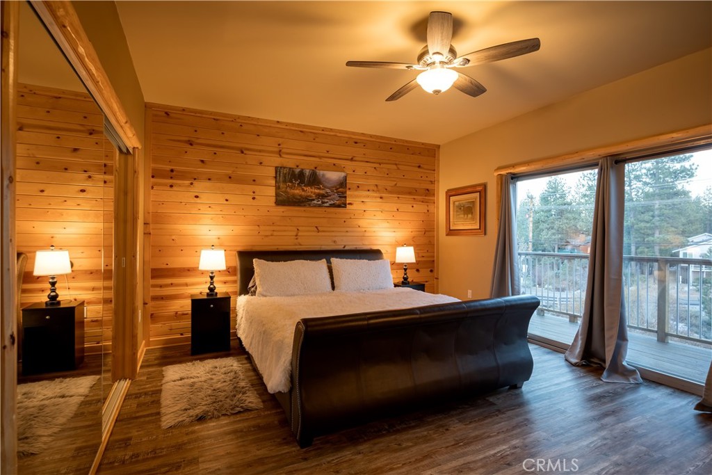 325 Stony Creek Road Big Bear Lake, CA 92315 - Photo 30 of 42 a bed room with a bed and a chandelier