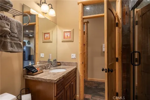 a bathroom with a sink vanity and a mirror