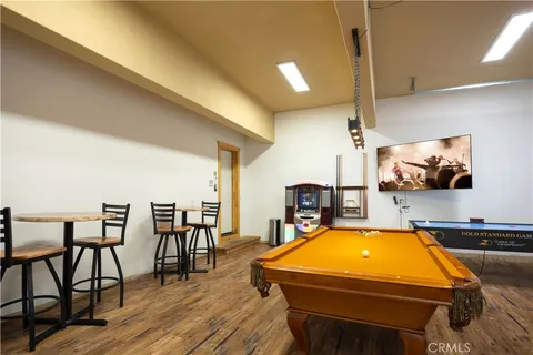 a room with table tennis air hockey table and arcade game machine