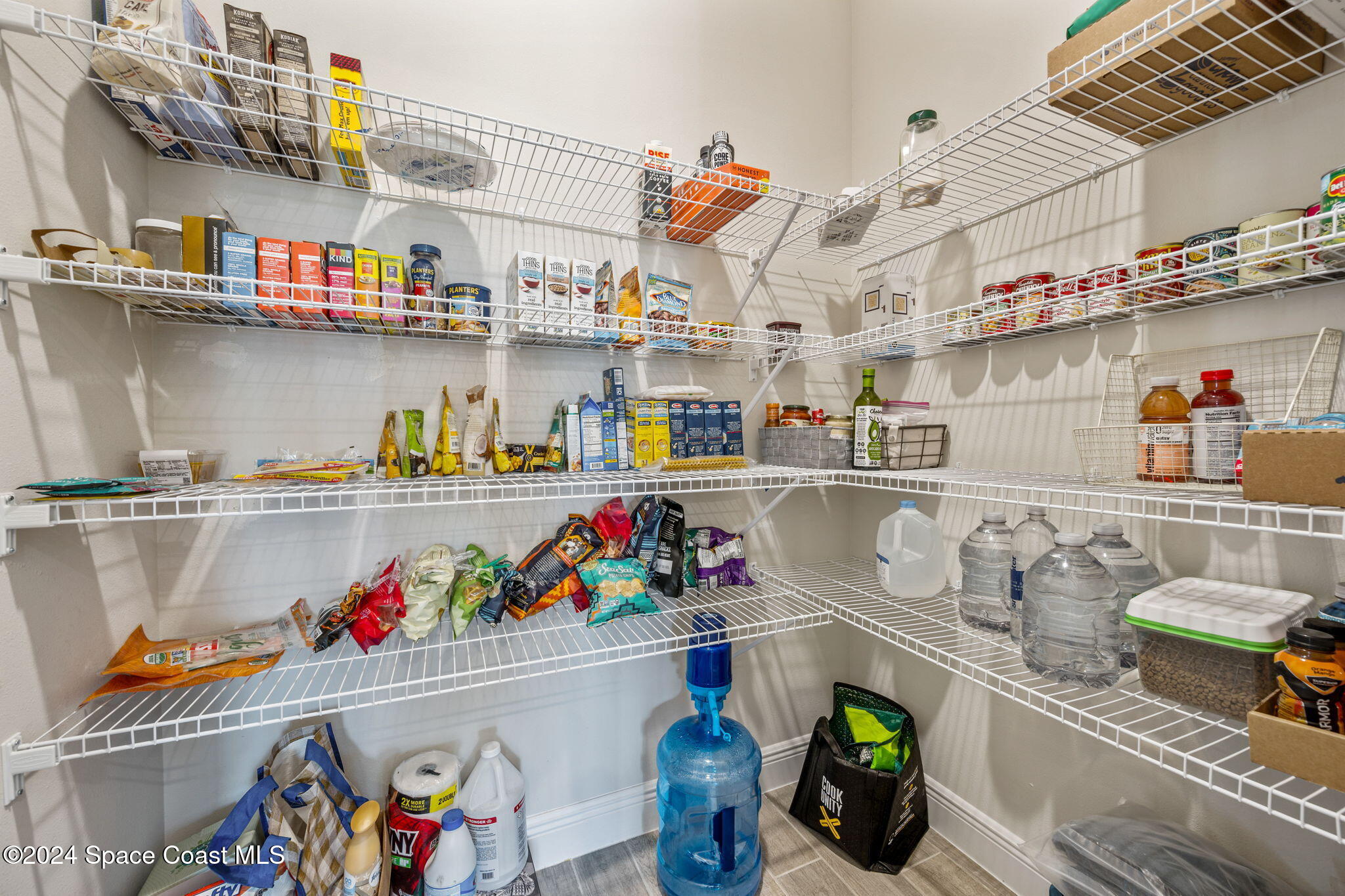 3500 Rixford Way Palm Bay, FL 32909 - Photo 11 of 55 a store room with lots of clutter and white cabinets
