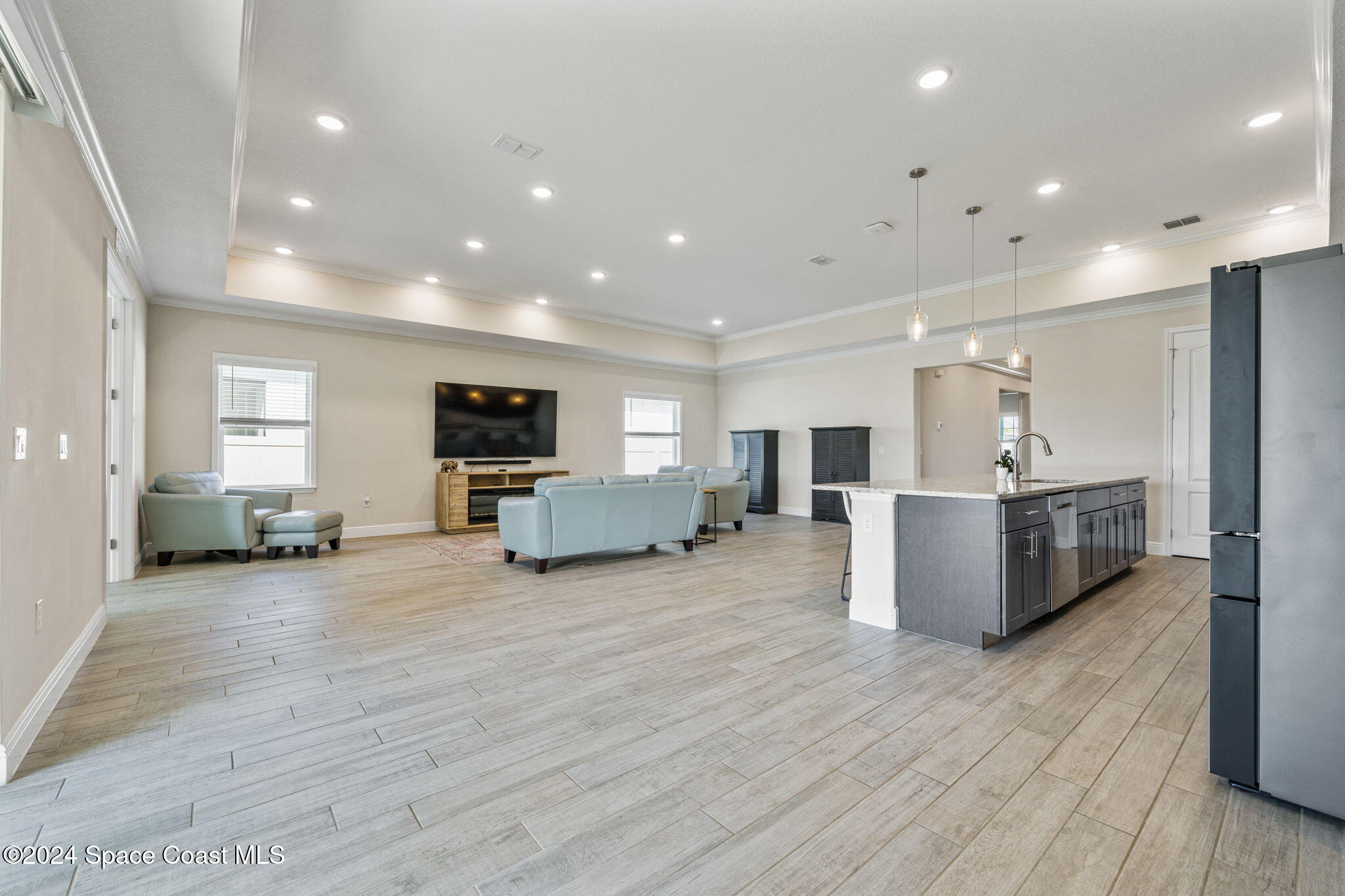 3500 Rixford Way Palm Bay, FL 32909 - Photo 13 of 55 a large living room with stainless steel appliances kitchen island a large counter top and couch