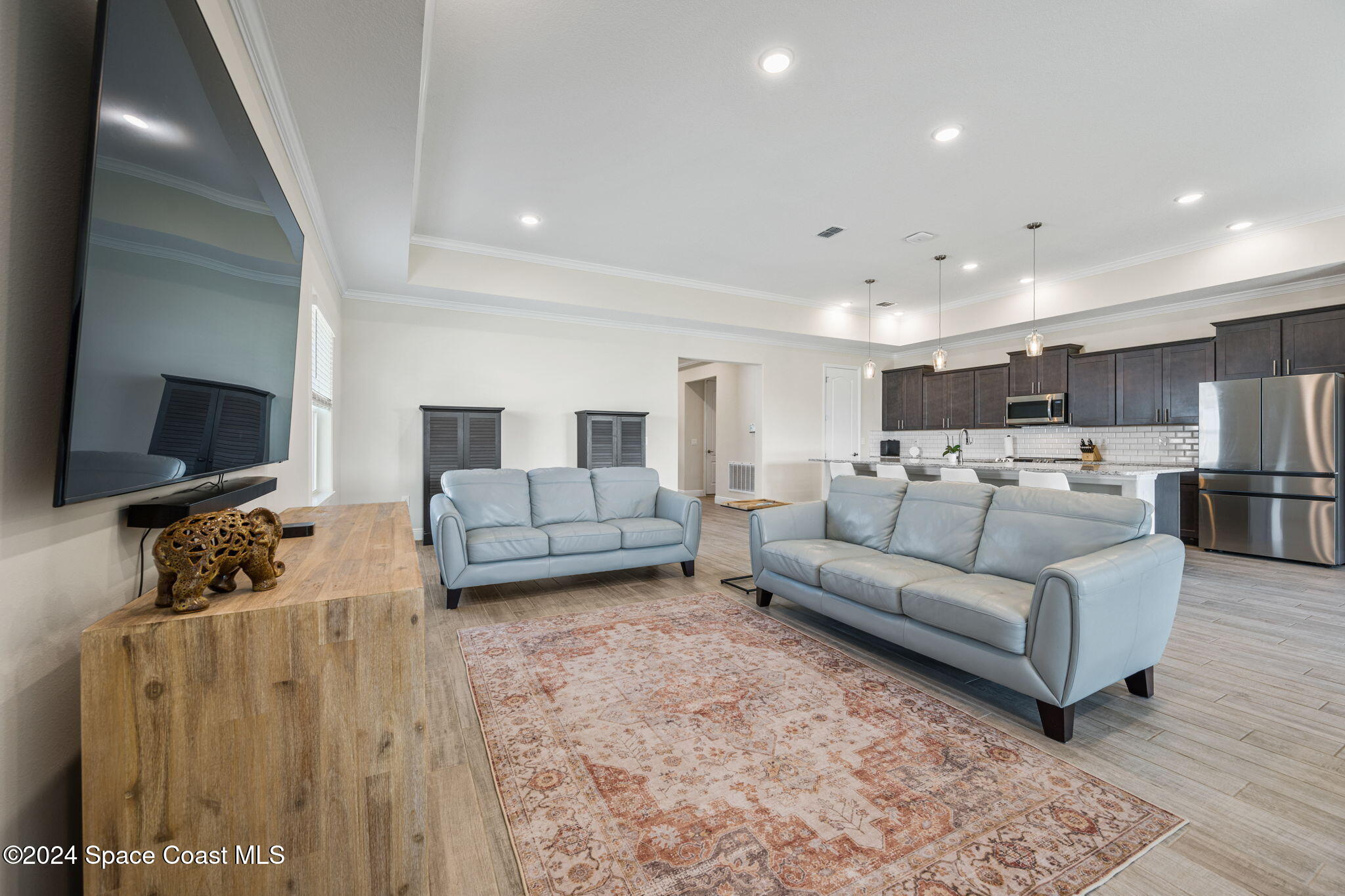 3500 Rixford Way Palm Bay, FL 32909 - Photo 17 of 55 a living room with furniture flat screen tv and couches