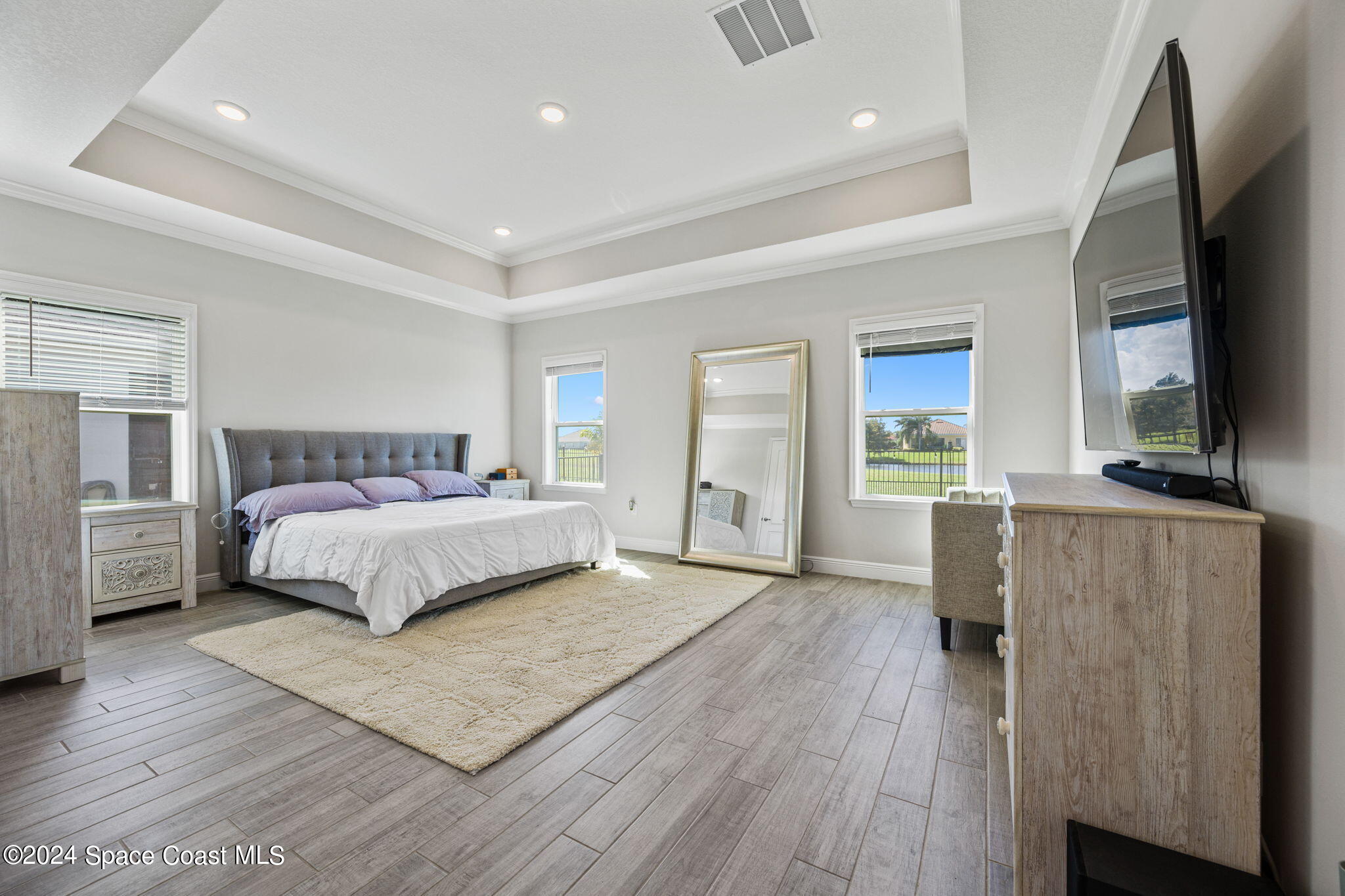 3500 Rixford Way Palm Bay, FL 32909 - Photo 19 of 55 a bedroom with a large bed a flat tv screen and dresser