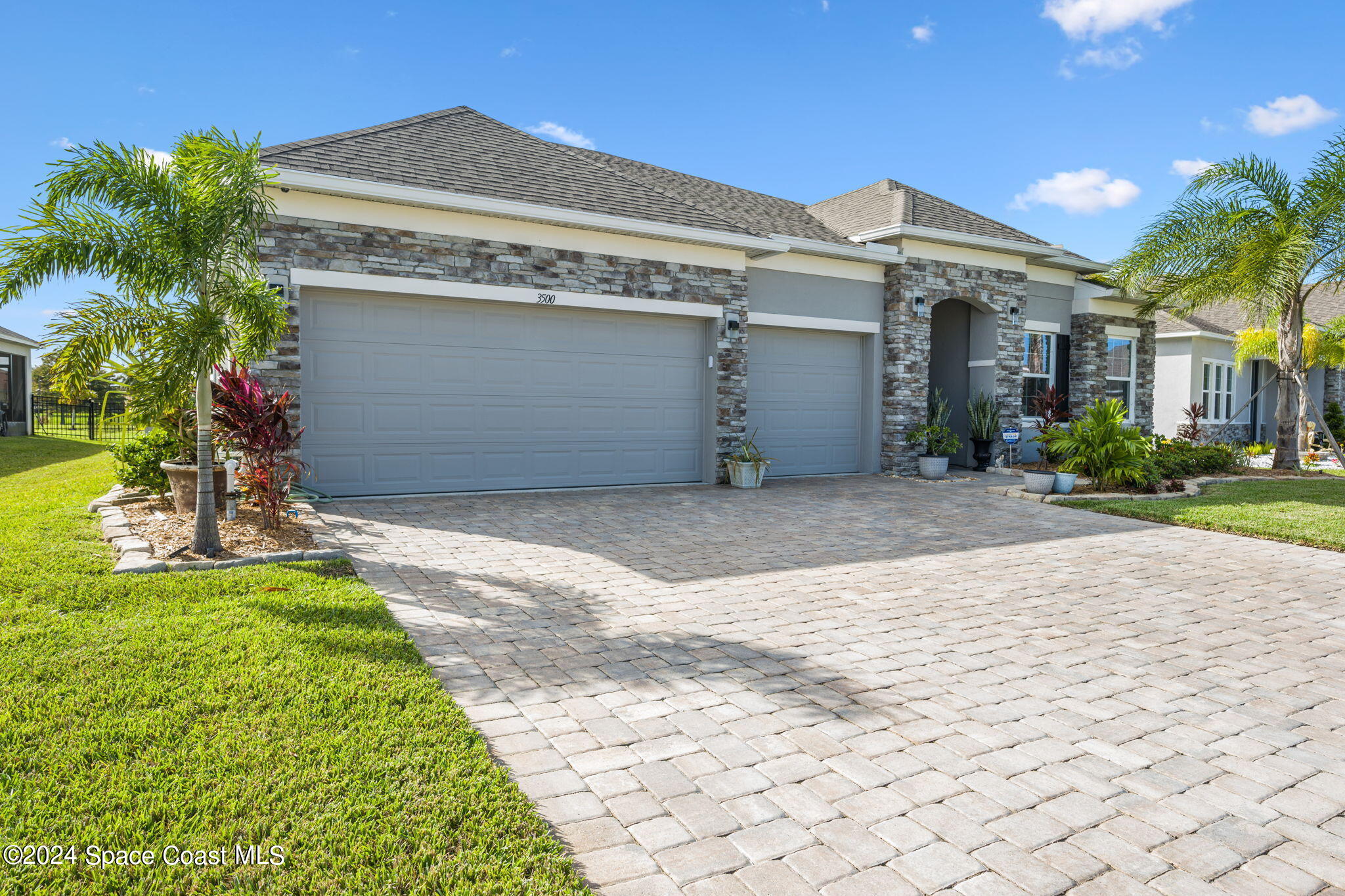 3500 Rixford Way Palm Bay, FL 32909 - Photo 2 of 55 a front view of a house with a yard and garage