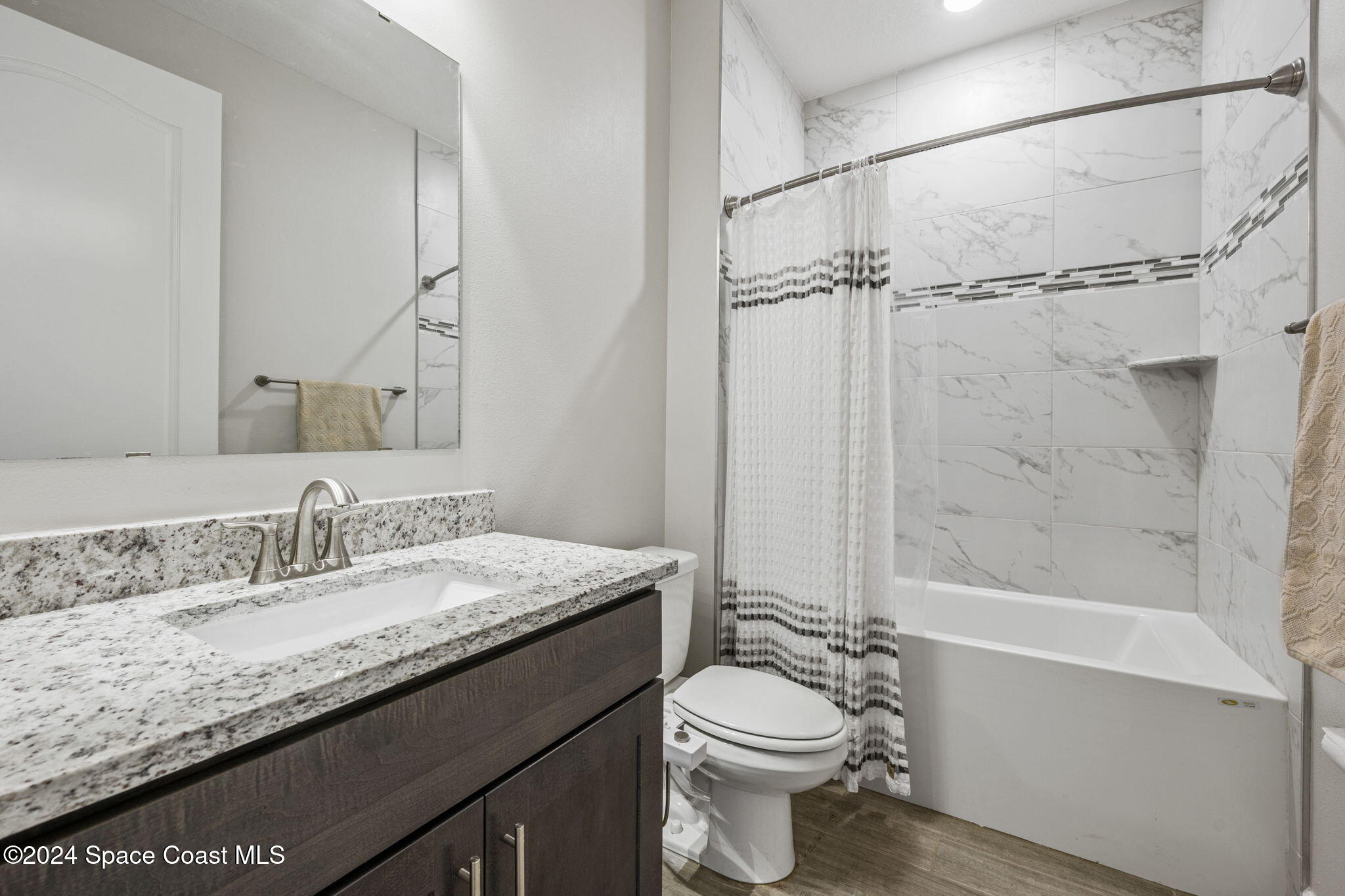 3500 Rixford Way Palm Bay, FL 32909 - Photo 25 of 55 a bathroom with a granite countertop sink toilet and shower