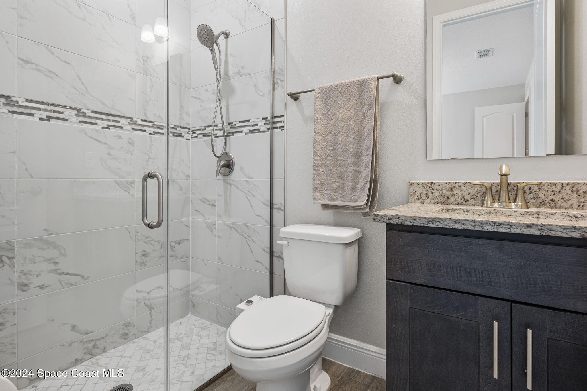 3500 Rixford Way Palm Bay, FL 32909 - Photo 26 of 55 a bathroom with a granite countertop sink toilet and shower