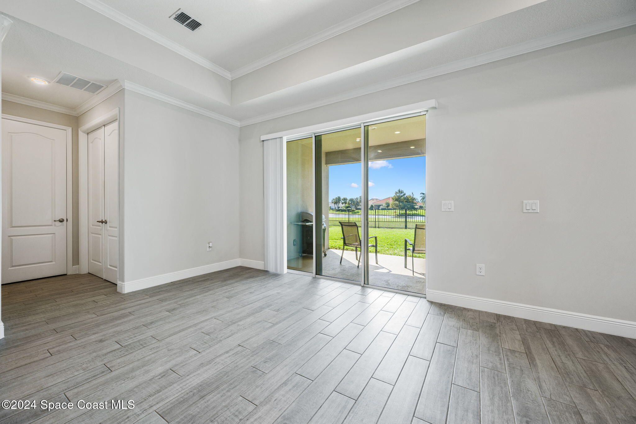 3500 Rixford Way Palm Bay, FL 32909 - Photo 36 of 55 an empty room with wooden floor and sliding door