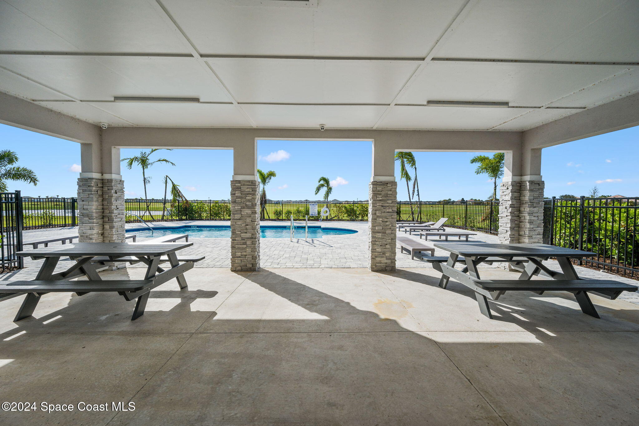 3500 Rixford Way Palm Bay, FL 32909 - Photo 48 of 55 a living room with furniture a floor to ceiling window and a flat screen tv