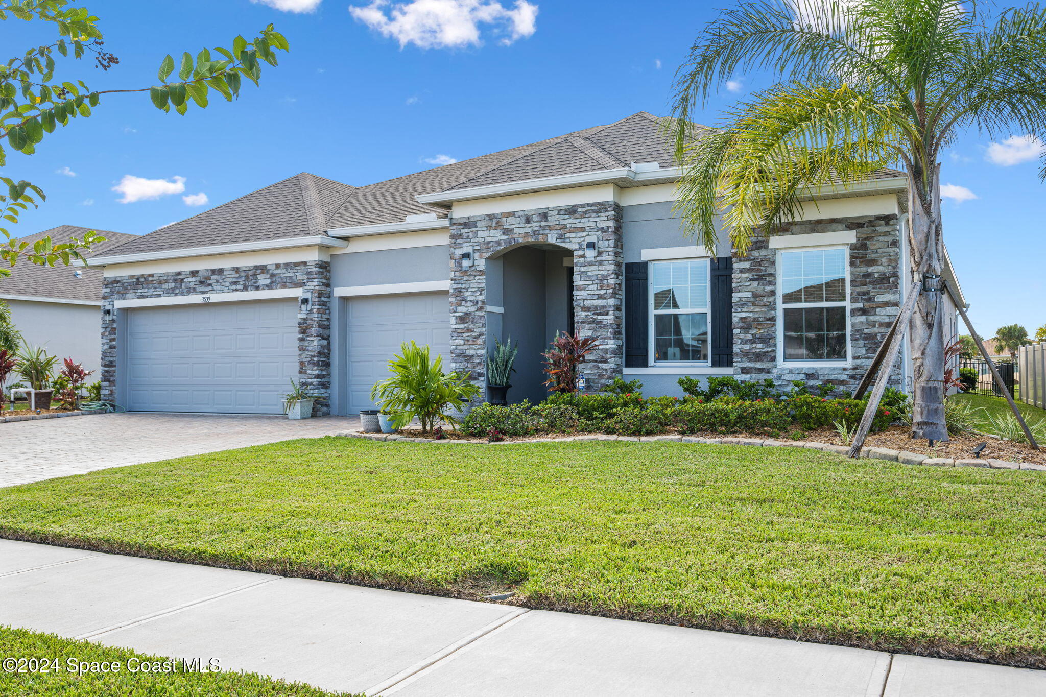 3500 Rixford Way Palm Bay, FL 32909 - Photo 55 of 55 a front view of a house with a yard and palm trees