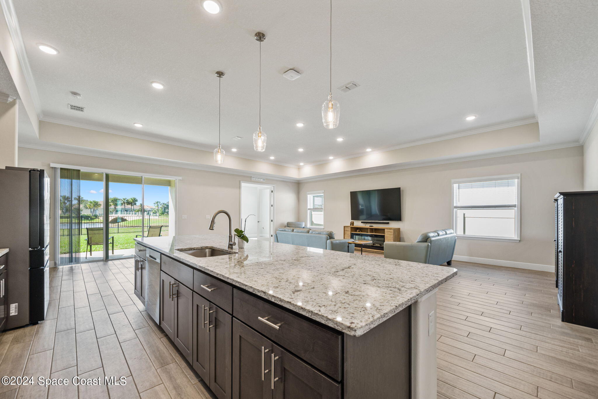 3500 Rixford Way Palm Bay, FL 32909 - Photo 7 of 55 a kitchen with granite countertop center island wooden floor and stainless steel appliances