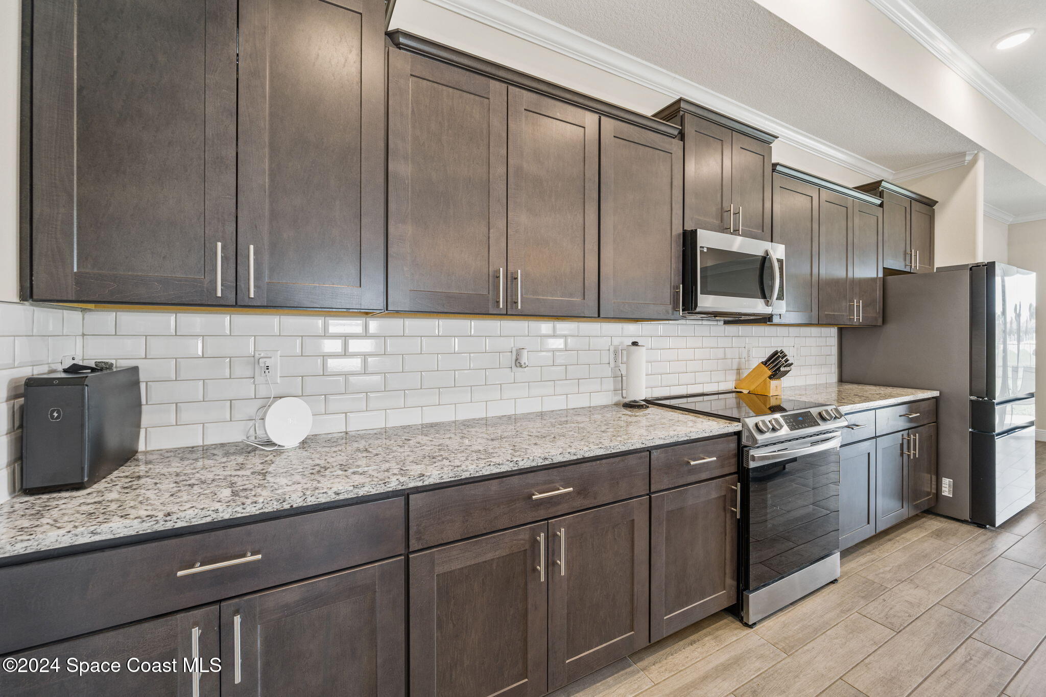 3500 Rixford Way Palm Bay, FL 32909 - Photo 9 of 55 a kitchen with stainless steel appliances granite countertop a sink stove and refrigerator
