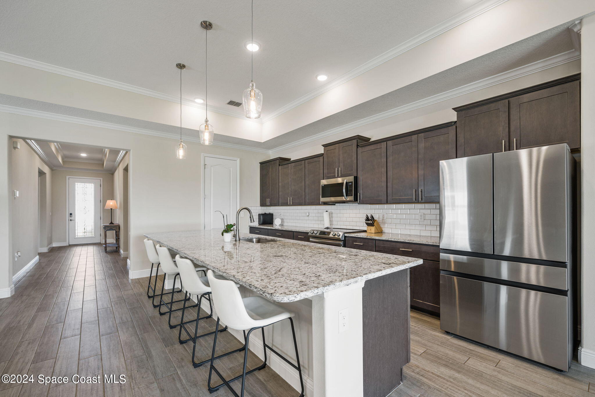 3500 Rixford Way Palm Bay, FL 32909 - Photo 10 of 55 a kitchen with stainless steel appliances granite countertop a refrigerator a sink dishwasher a stove and a refrigerator