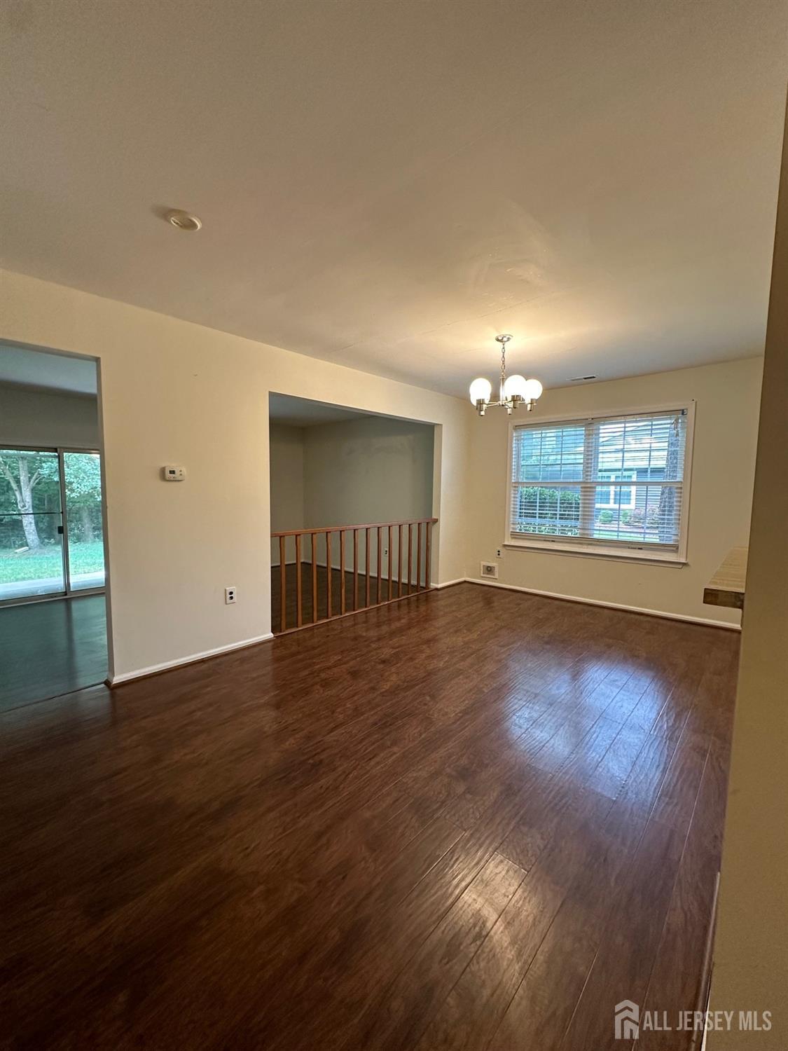 315 Constitution Circle North Brunswick, NJ 08902 - Photo 2 of 9 a view of empty room with wooden floor and fan