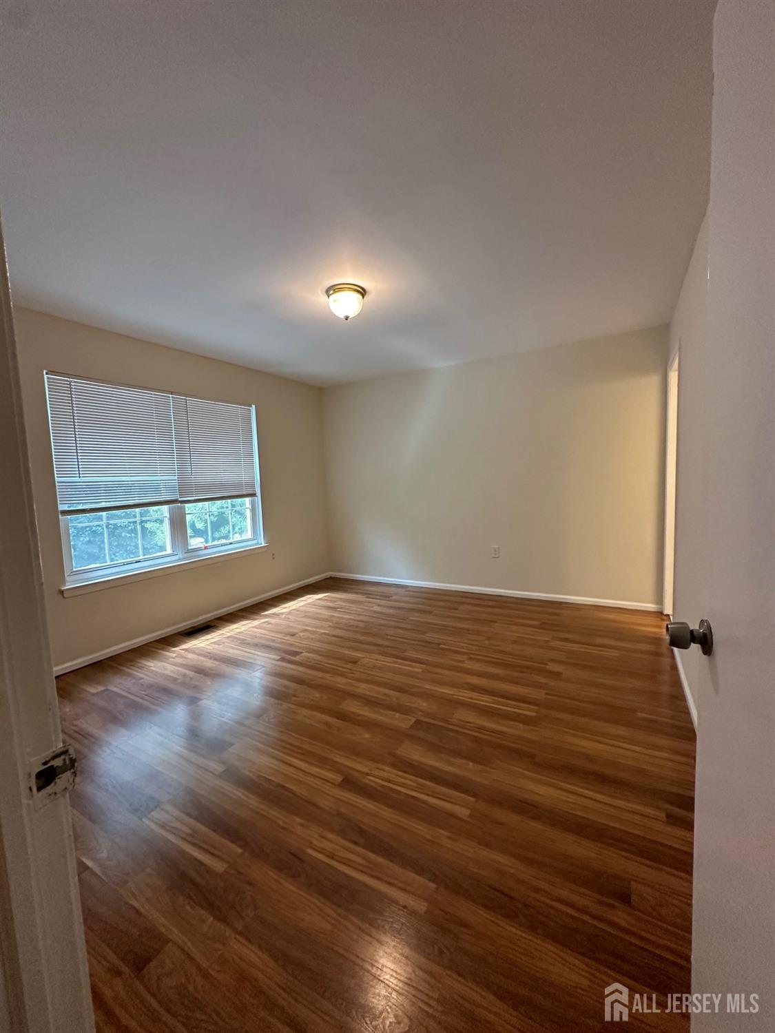 315 Constitution Circle North Brunswick, NJ 08902 - Photo 5 of 9 wooden floor in an empty room with a window