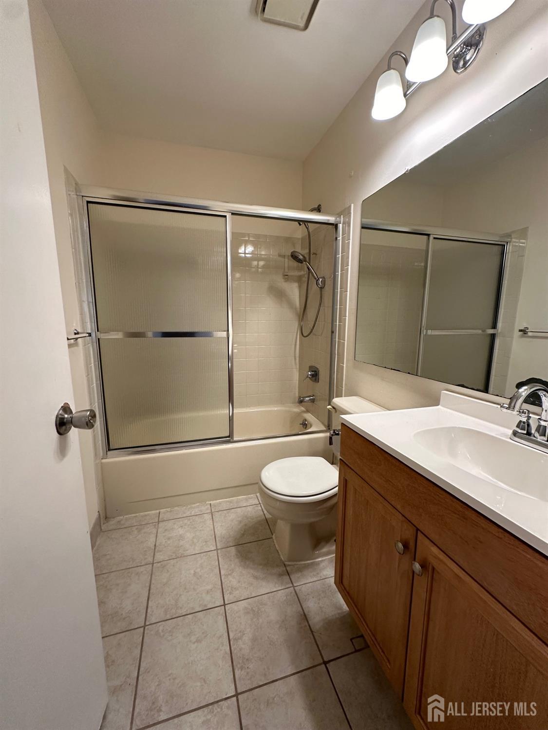 315 Constitution Circle North Brunswick, NJ 08902 - Photo 7 of 9 a bathroom with a toilet a sink and shower