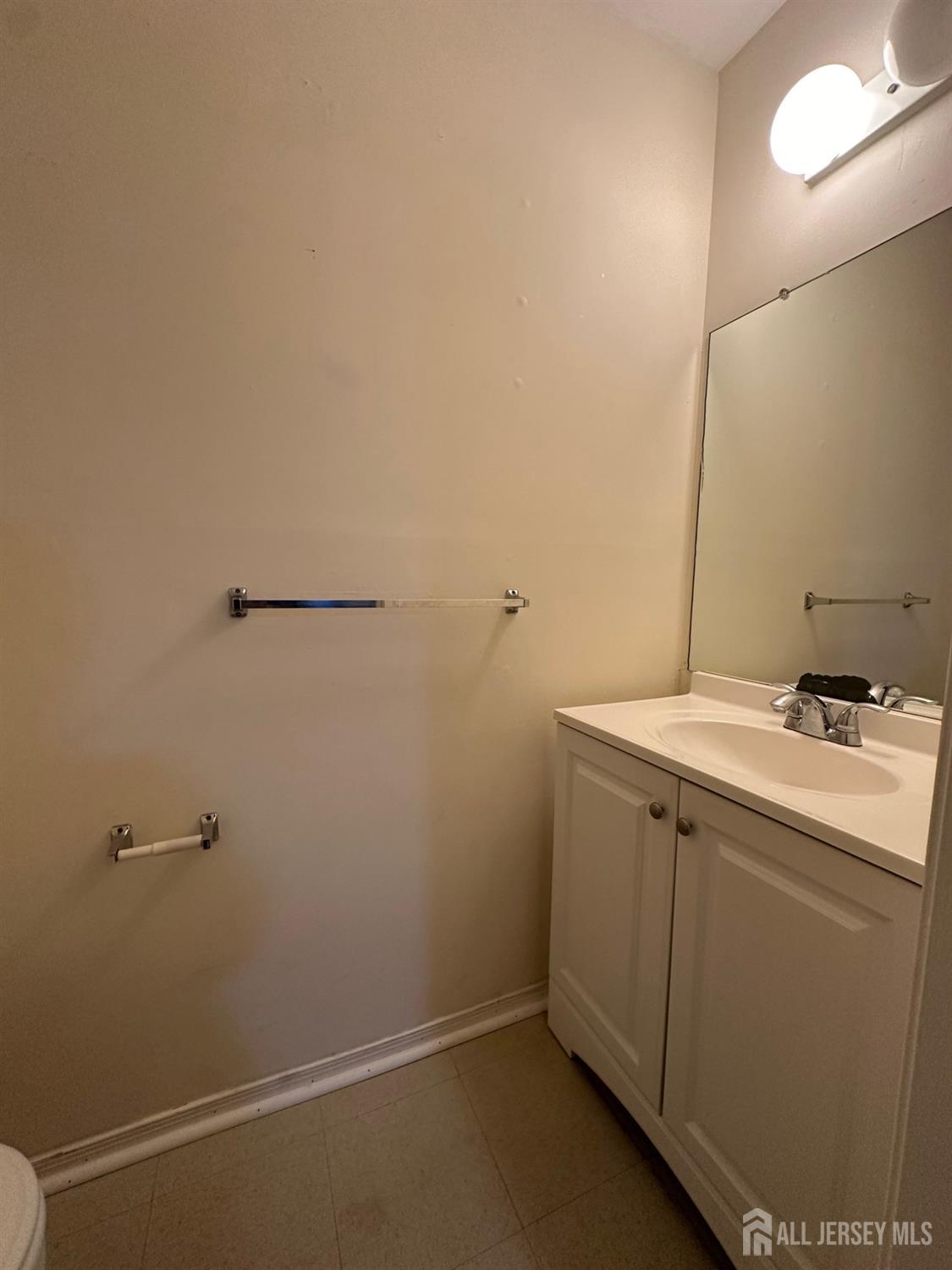315 Constitution Circle North Brunswick, NJ 08902 - Photo 9 of 9 a bathroom with a sink and mirror