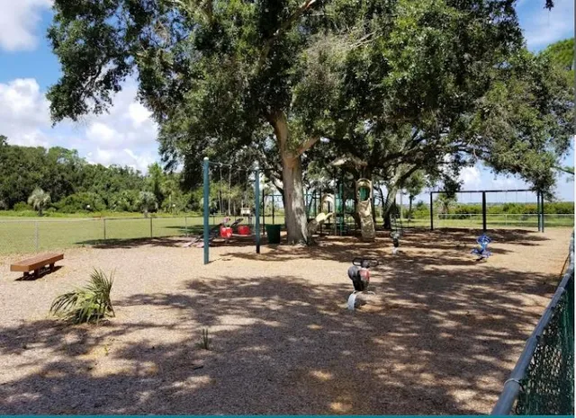 a view of a house with a yard and potted plants
