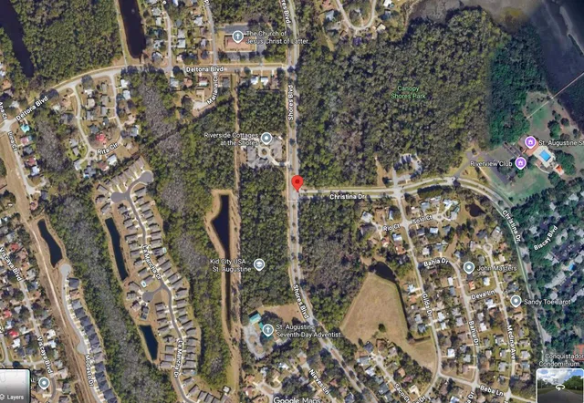 a view of a tennis ground with large trees