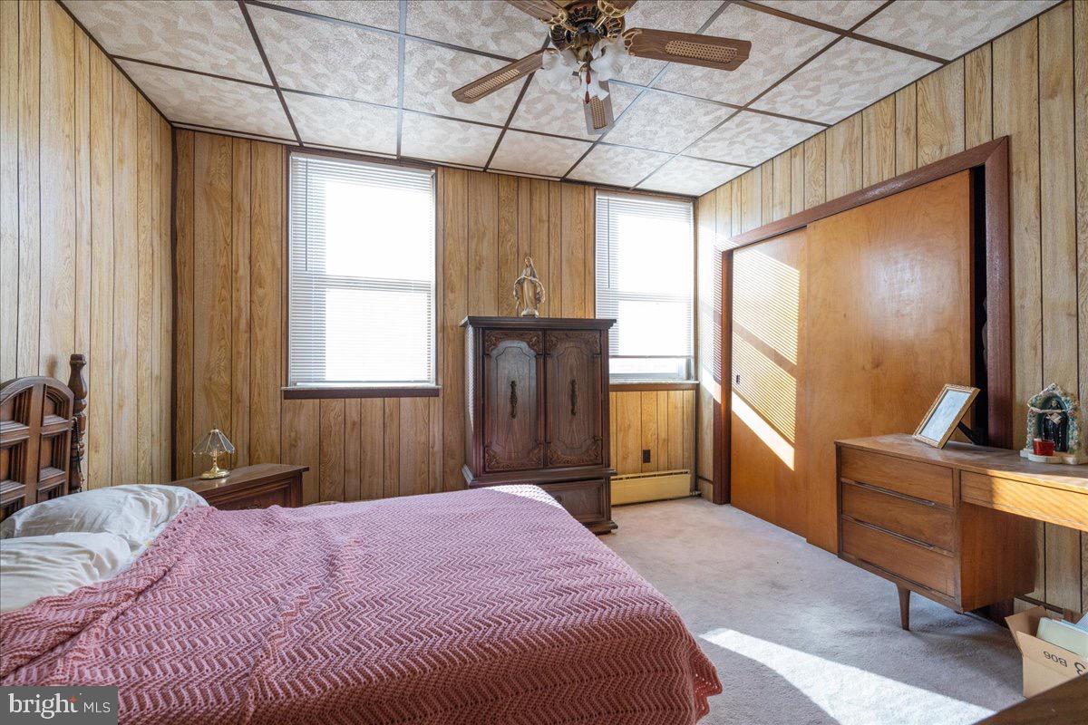 1229 Jackson Street Philadelphia, PA 19148 - Photo 12 of 29 a bedroom with a bed dresser and a flat tv screen