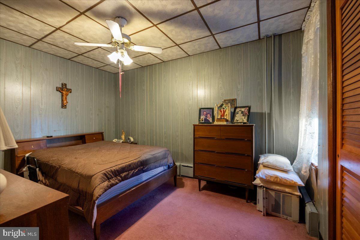 1229 Jackson Street Philadelphia, PA 19148 - Photo 14 of 29 a bedroom with a bed and a chandelier