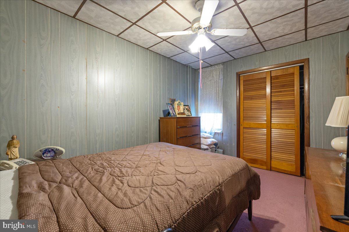 1229 Jackson Street Philadelphia, PA 19148 - Photo 15 of 29 a bedroom with a bed and a chandelier
