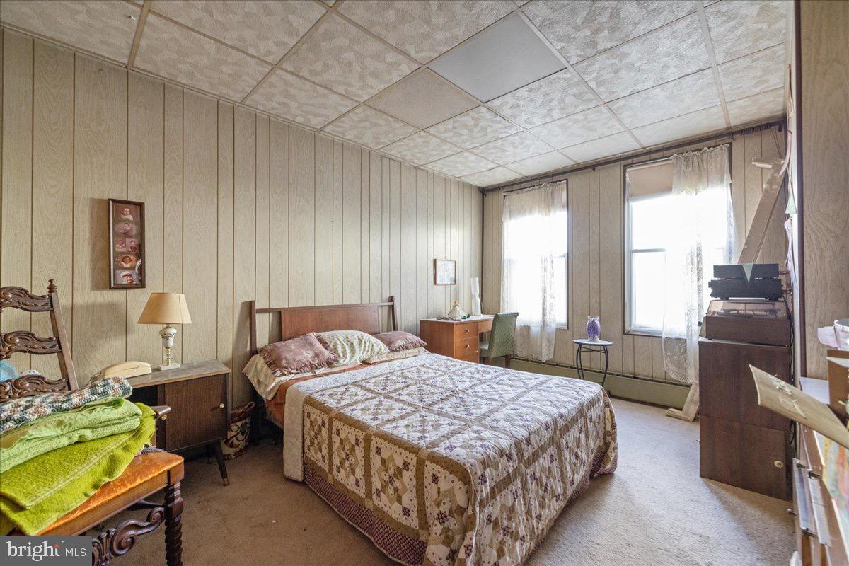 1229 Jackson Street Philadelphia, PA 19148 - Photo 17 of 29 a bedroom with a bed and a chandelier