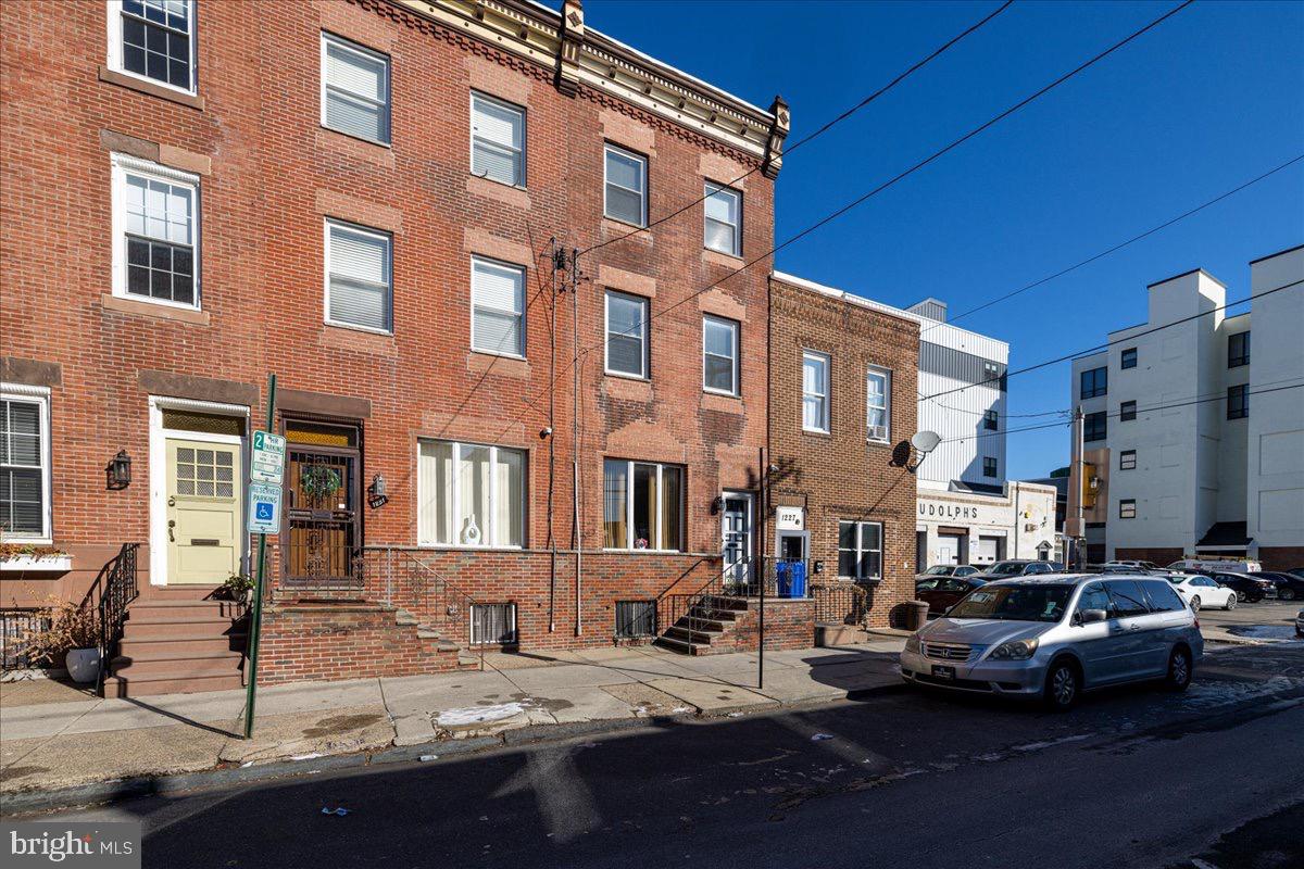 1229 Jackson Street Philadelphia, PA 19148 - Photo 2 of 29 a view of a street with cars and buildings