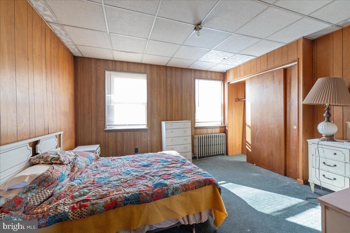 1229 Jackson Street Philadelphia, PA 19148 - Photo 21 of 29 a bedroom with a bed and wooden floor