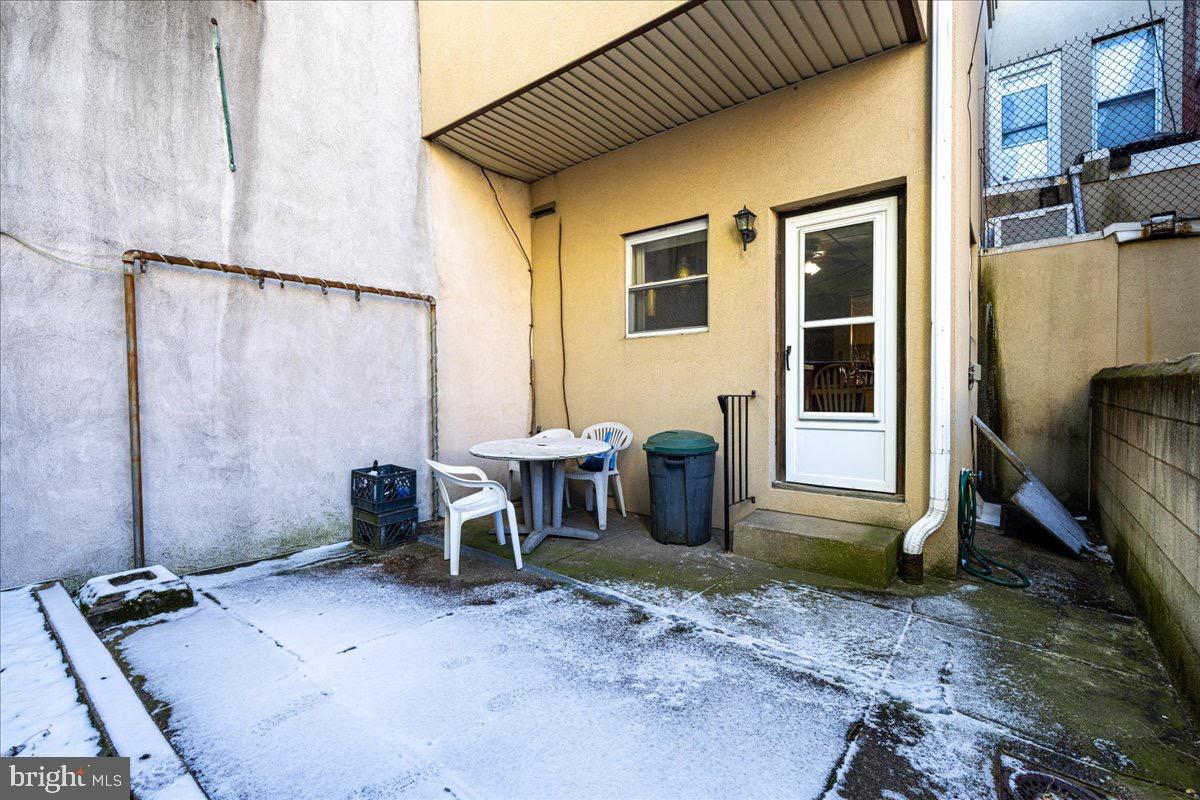 1229 Jackson Street Philadelphia, PA 19148 - Photo 25 of 29 a backyard of a house with table and chairs