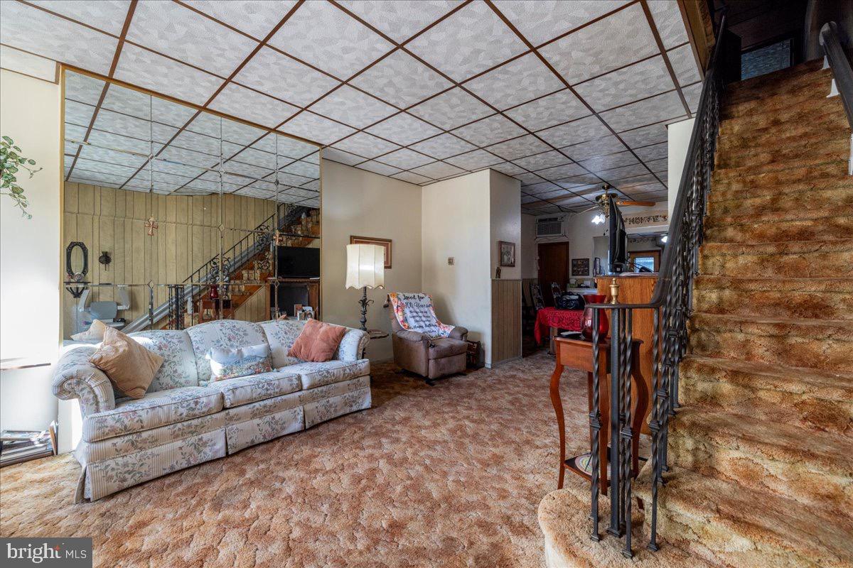 1229 Jackson Street Philadelphia, PA 19148 - Photo 4 of 29 a living room with furniture and a gym machine with wooden floor