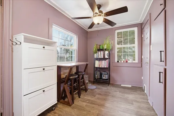 a kitchen with white cabinets and appliances