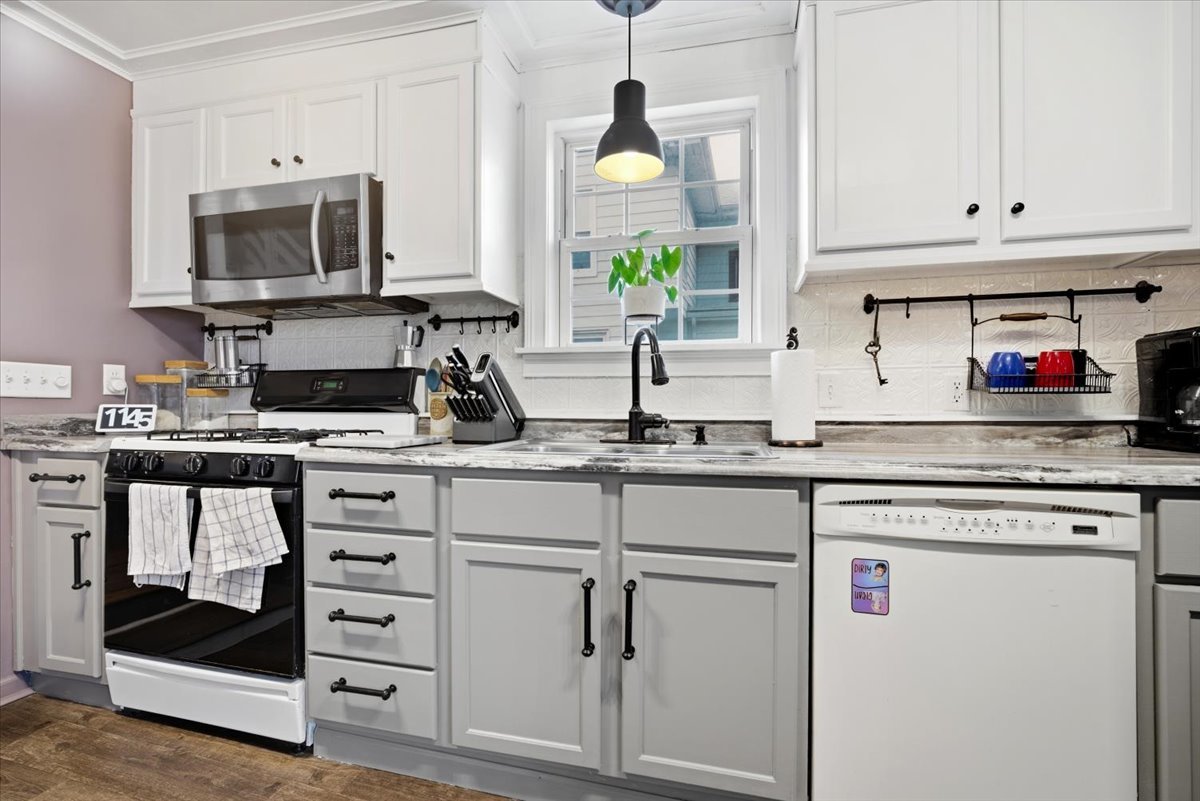511 East Chestnut Street Bloomington, IL 61701 - Photo 15 of 32 a kitchen with white cabinets and appliances