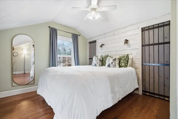 a bedroom with a large bed and a window