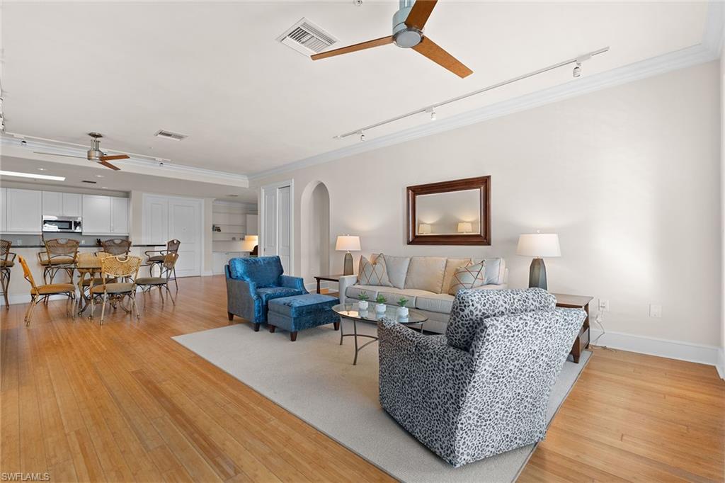 780 5th Avenue South, Unit 306 Naples, FL 34102 - Photo 11 of 31 a living room with furniture and wooden floor