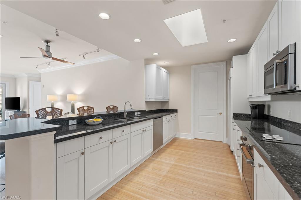 780 5th Avenue South, Unit 306 Naples, FL 34102 - Photo 15 of 31 a large kitchen with stainless steel appliances granite countertop a sink and cabinets