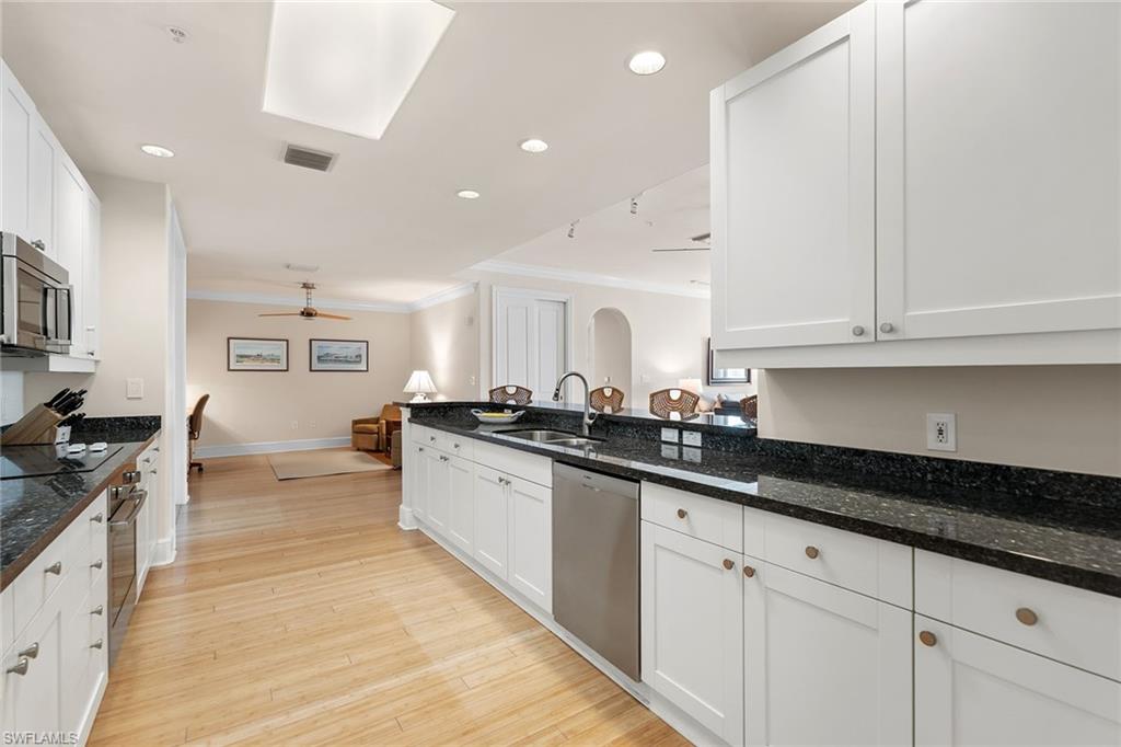 780 5th Avenue South, Unit 306 Naples, FL 34102 - Photo 16 of 31 a kitchen with granite countertop a sink and cabinets