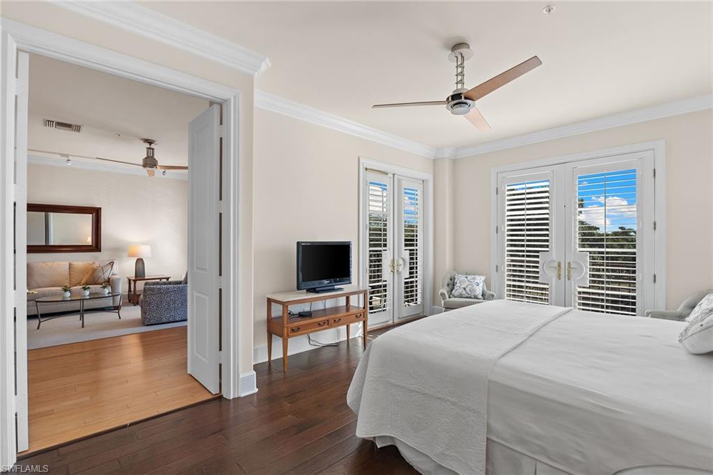 780 5th Avenue South, Unit 306 Naples, FL 34102 - Photo 18 of 31 a bedroom with a bed and wooden floor