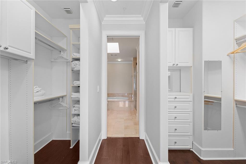 780 5th Avenue South, Unit 306 Naples, FL 34102 - Photo 19 of 31 a view of walk in closet with wooden floor