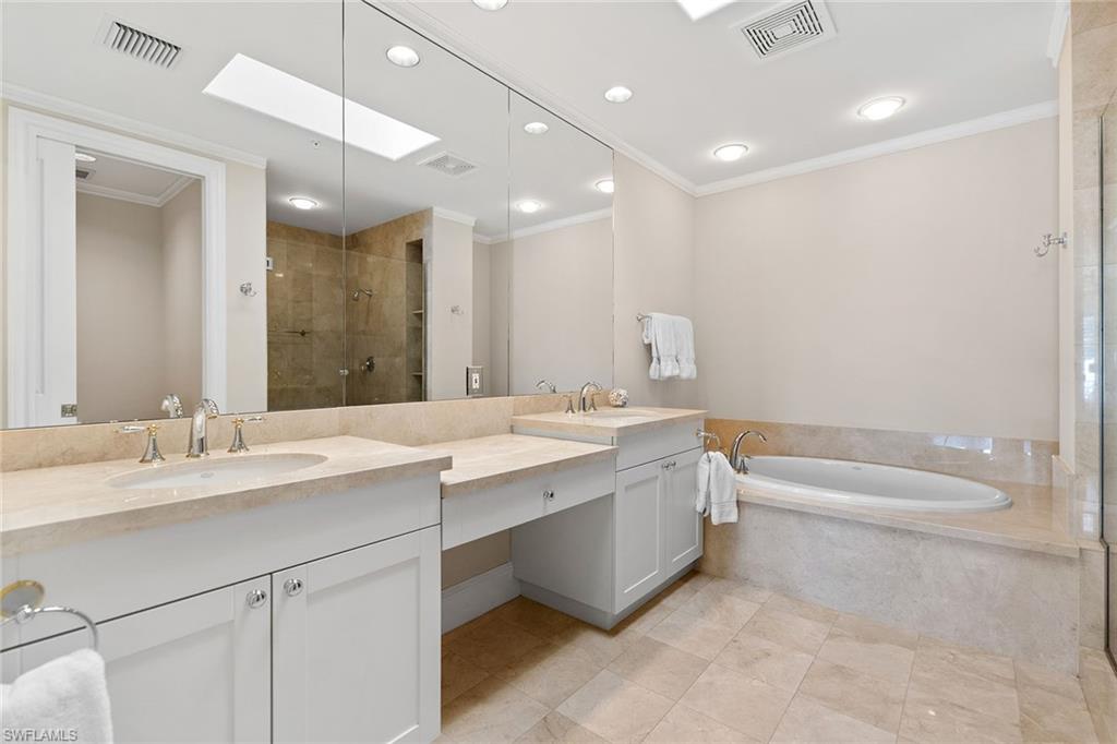 780 5th Avenue South, Unit 306 Naples, FL 34102 - Photo 21 of 31 a bathroom with a double vanity sink mirror double and bathtub