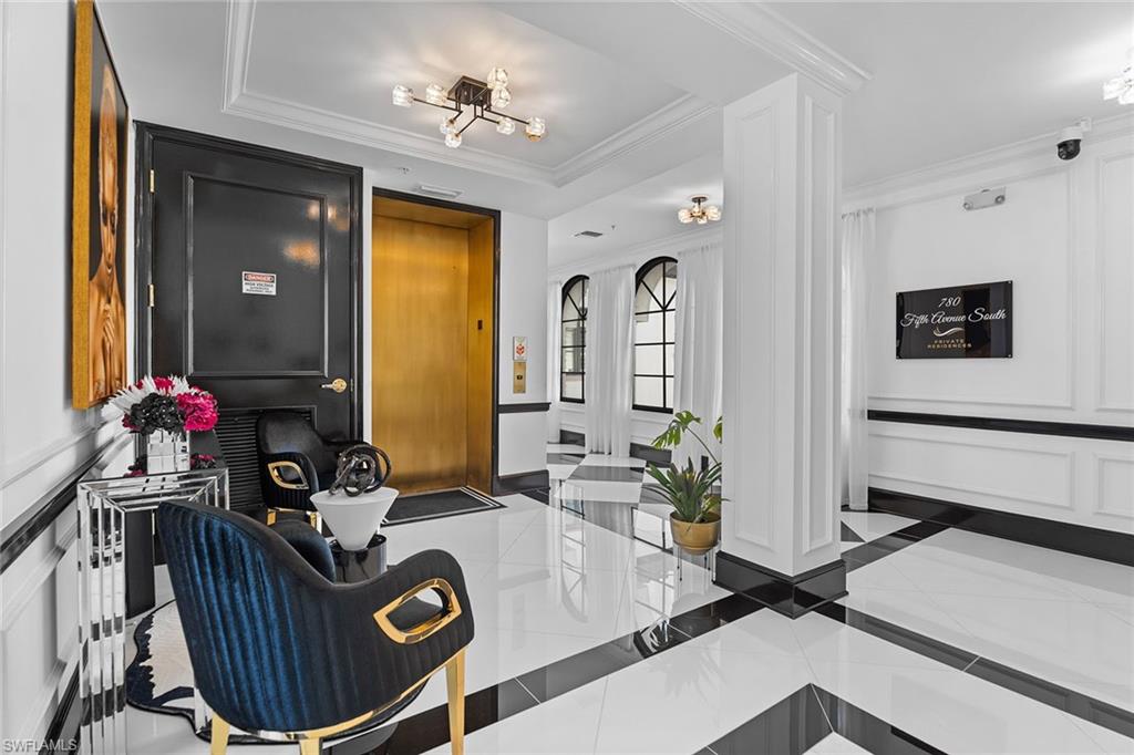 780 5th Avenue South, Unit 306 Naples, FL 34102 - Photo 3 of 31 a living room with furniture a window and a mirror