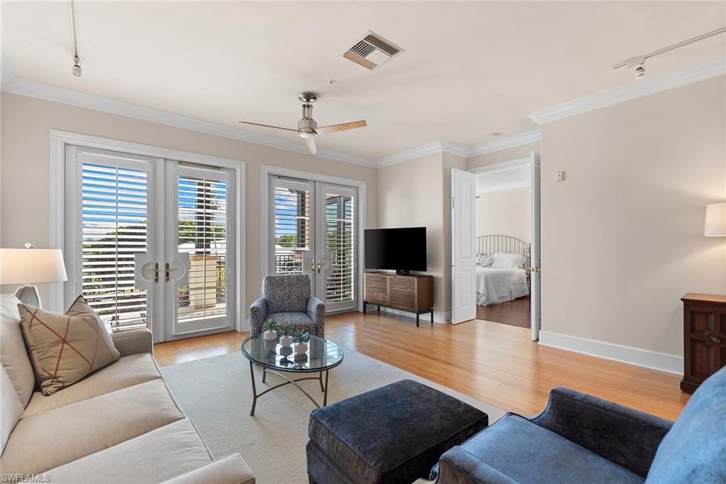 780 5th Avenue South, Unit 306 Naples, FL 34102 - Photo 7 of 31 a living room with furniture and a flat screen tv